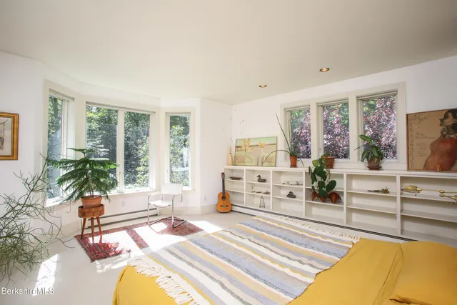 a spacious bedroom with a large bed and a large window