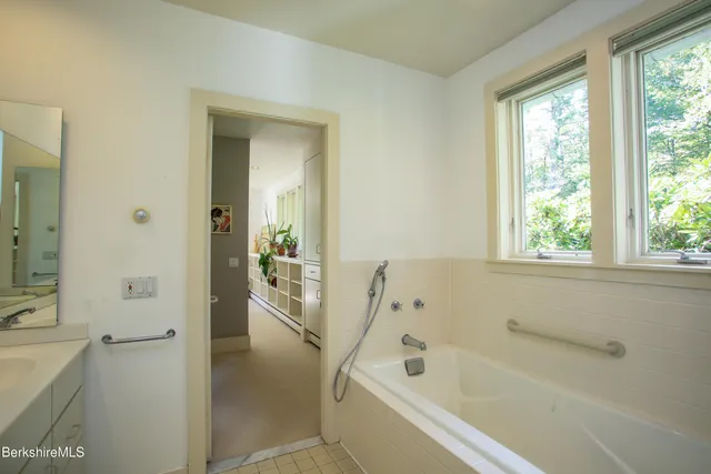 a bathroom with a bathtub and a shower