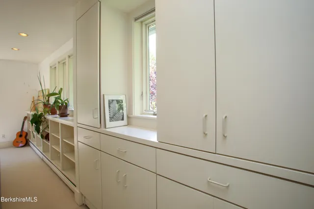 a view of a chair and tables in the balcony