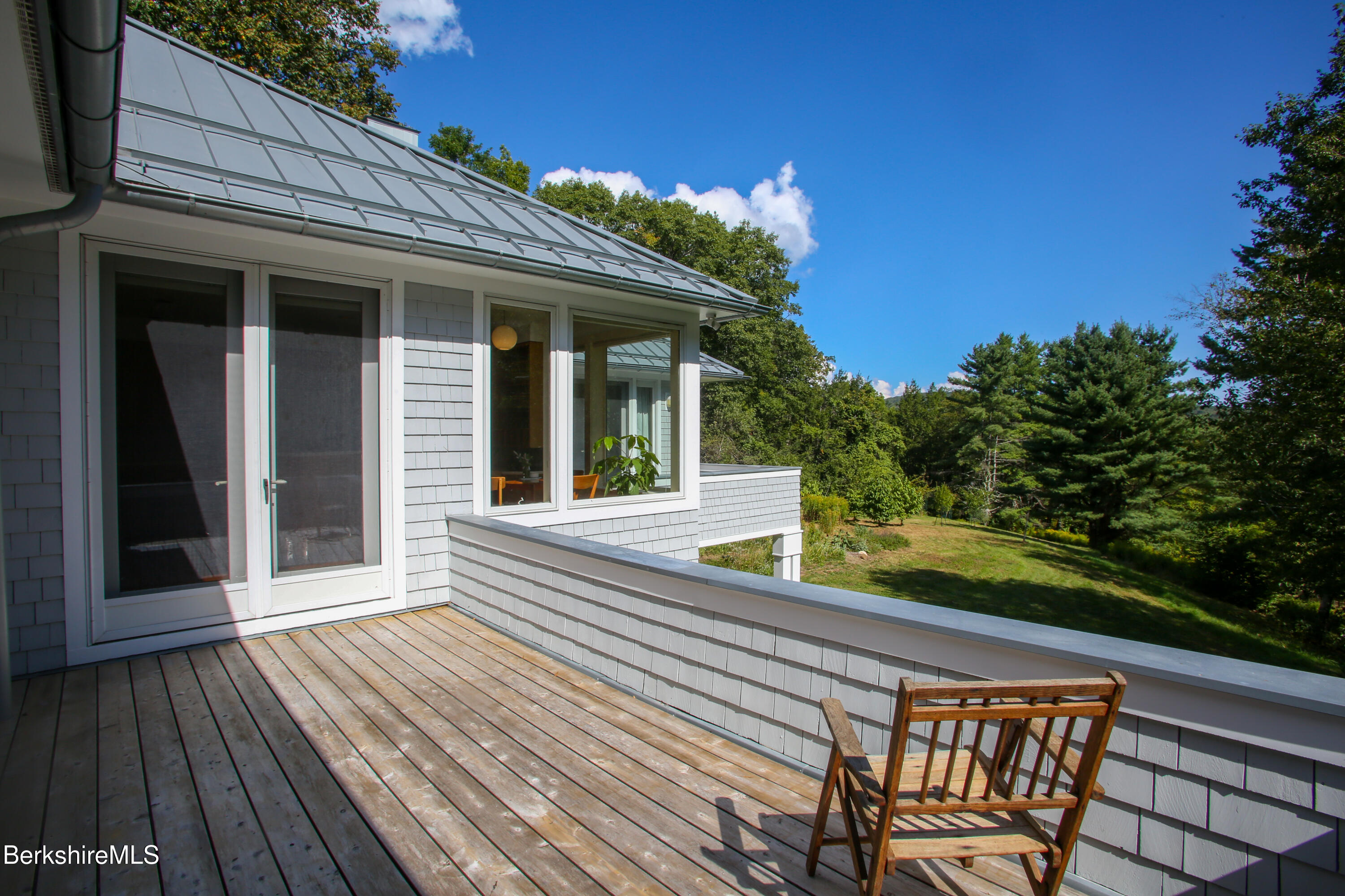 240 Beldingville Road Ashfield, MA 01330 - Photo 27 of 45 a view of a chair and tables in the balcony
