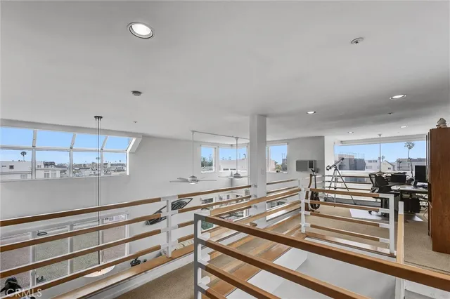 a view of a kitchen with kitchen island stainless steel appliances wooden cabinets and a counter top space