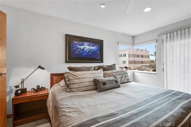 a bedroom with a bed and a large window