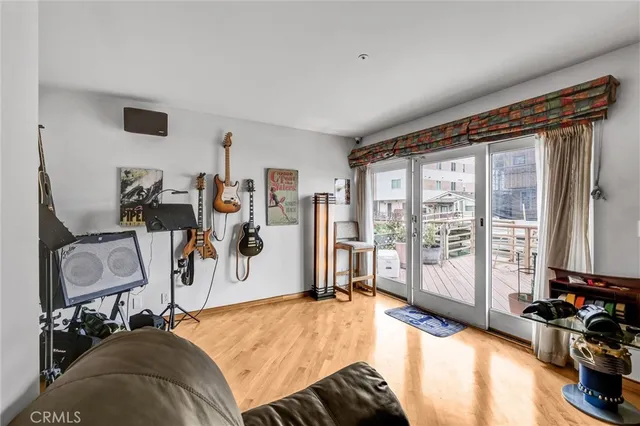 a bedroom with furniture a flat screen tv and a window