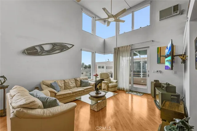 a living room with furniture a chandelier and a flat screen tv