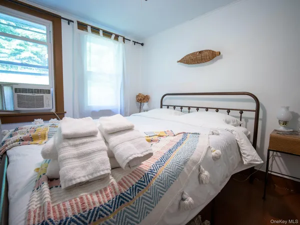 a bedroom with a bed and window