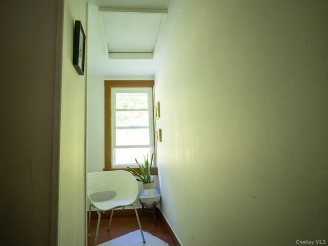 a bathroom with a chair and a window
