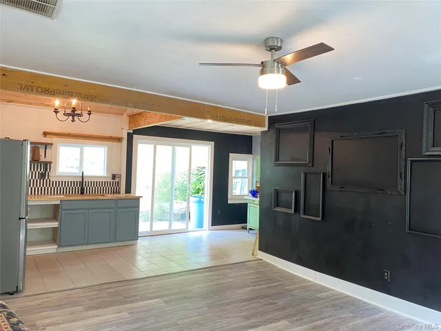 a view of a kitchen with a stove cabinets and a floor to ceiling window