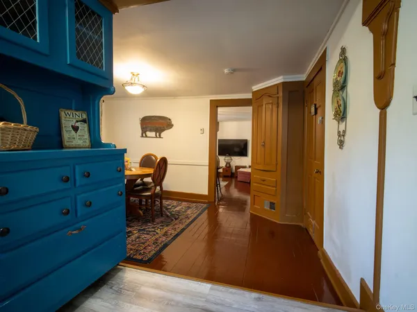 a living room with furniture and a baby crib