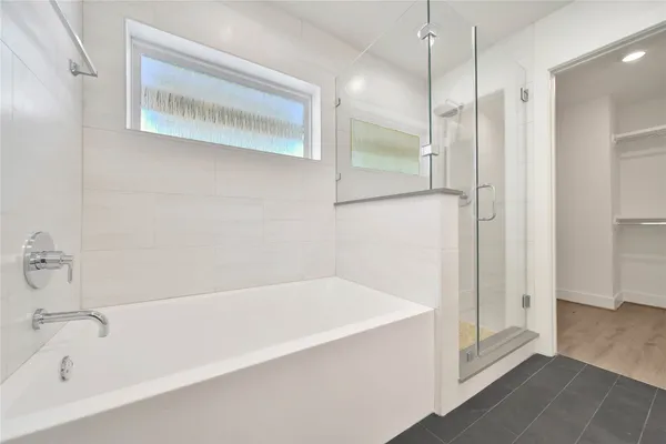 a bathroom with a bathtub and a shower