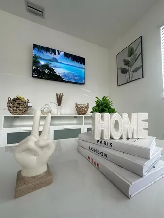 a living room with furniture and painting on the wall