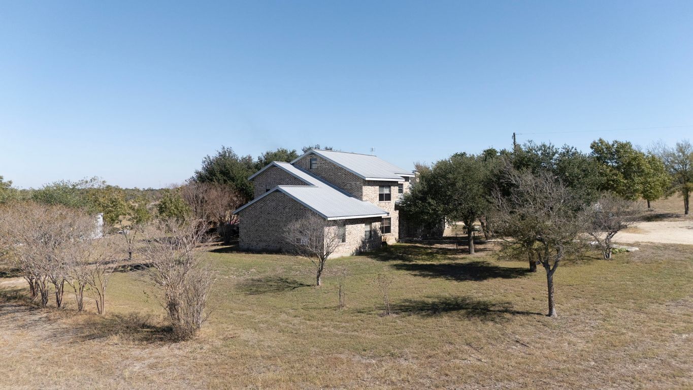 20181 Janak Road Coupland, TX 78615 - Photo 14 of 17 a view of a house with a yard