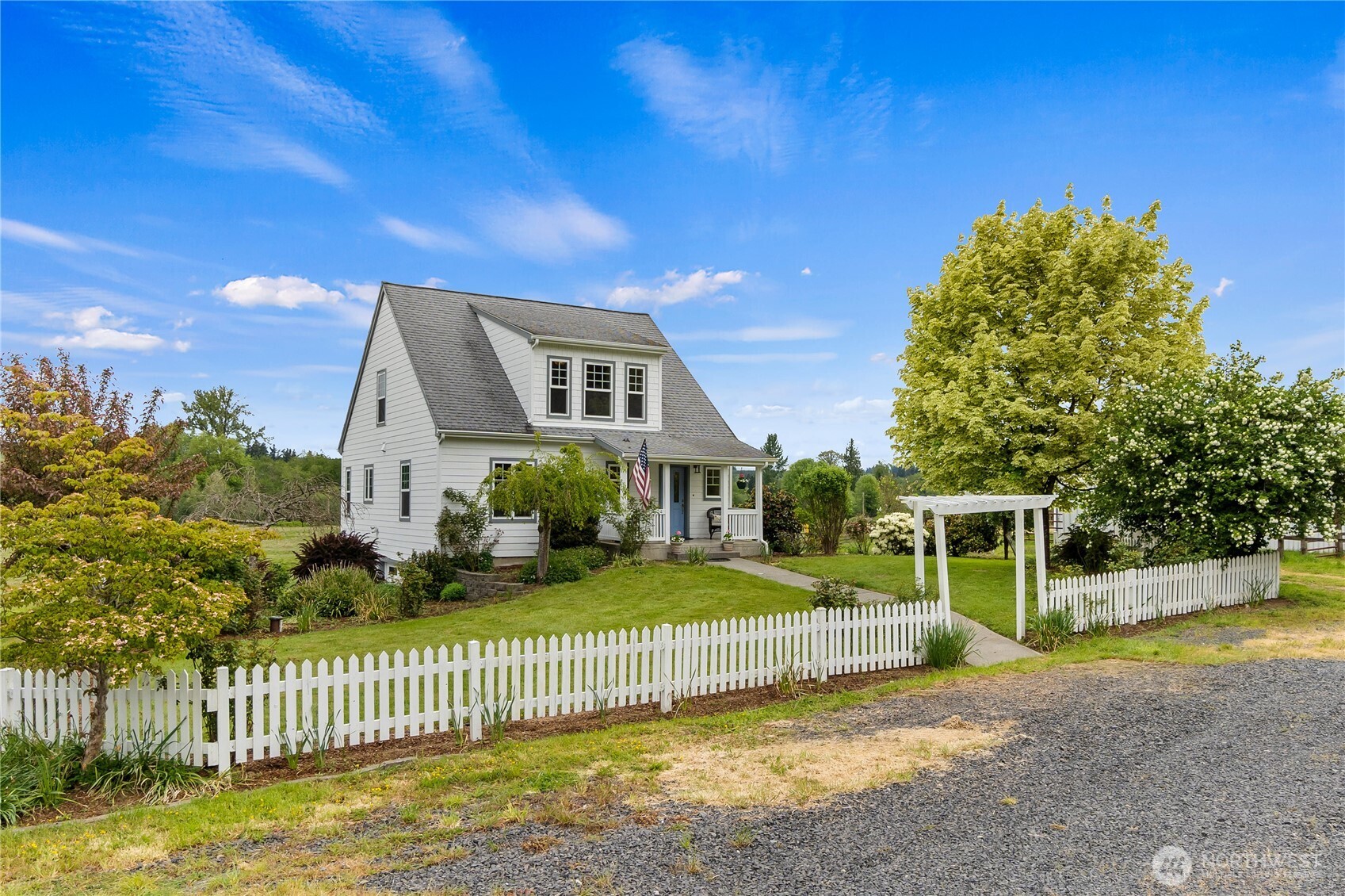 a view of a house with a yard and fence