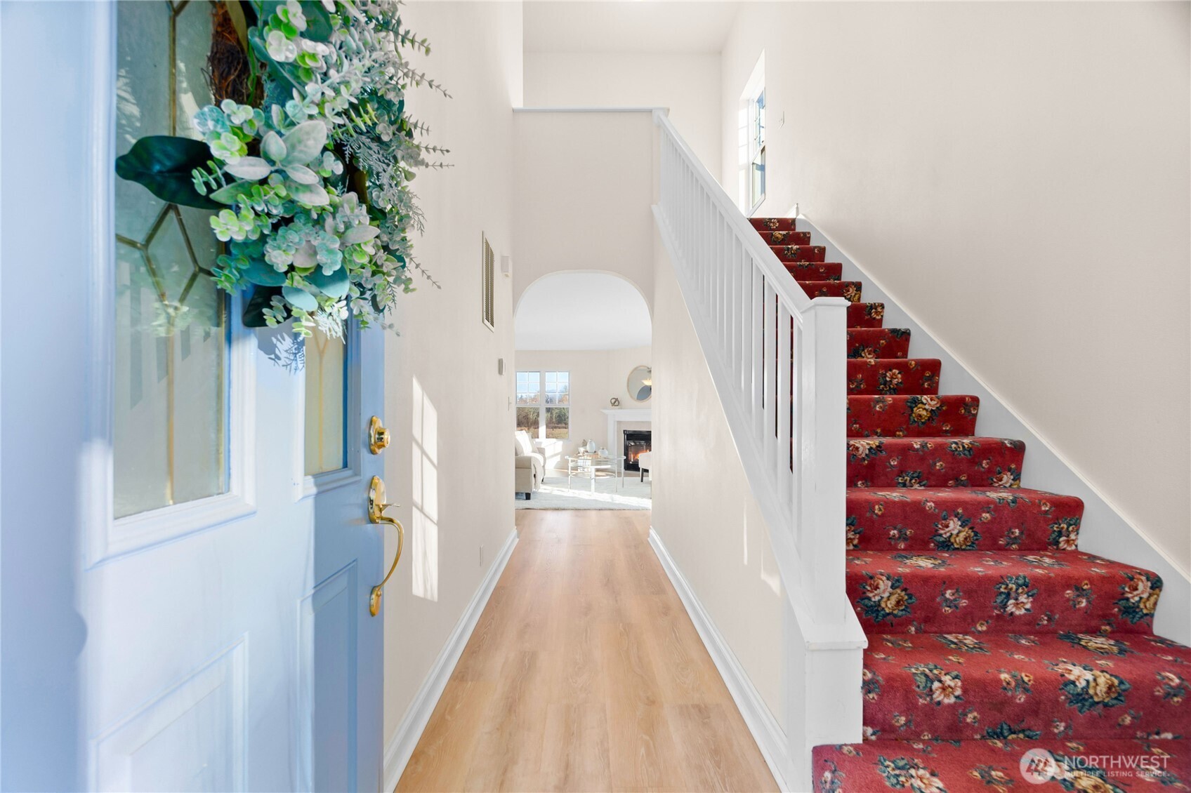 a view of a hallway with wooden floor and entryway