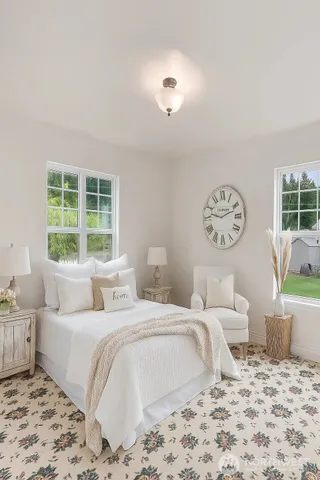 a bedroom with a large bed and a window