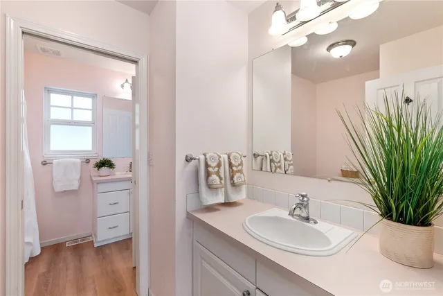 a bathroom with a sink a vanity and a mirror