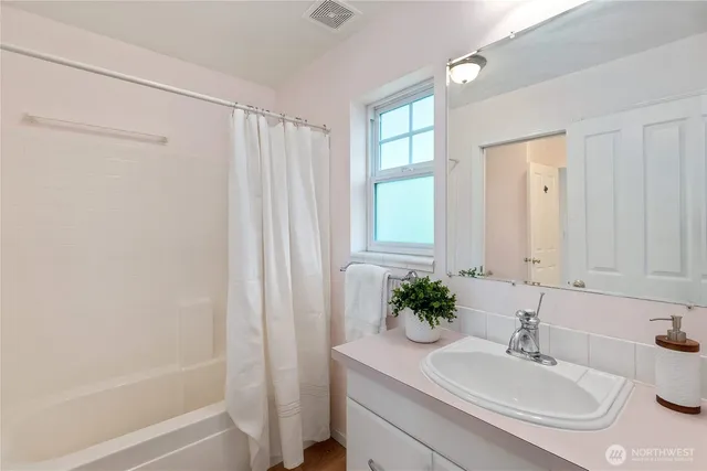 a bathroom with a sink a vanity and a mirror