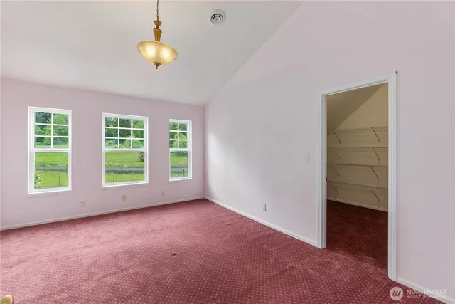 an empty room with windows and closet