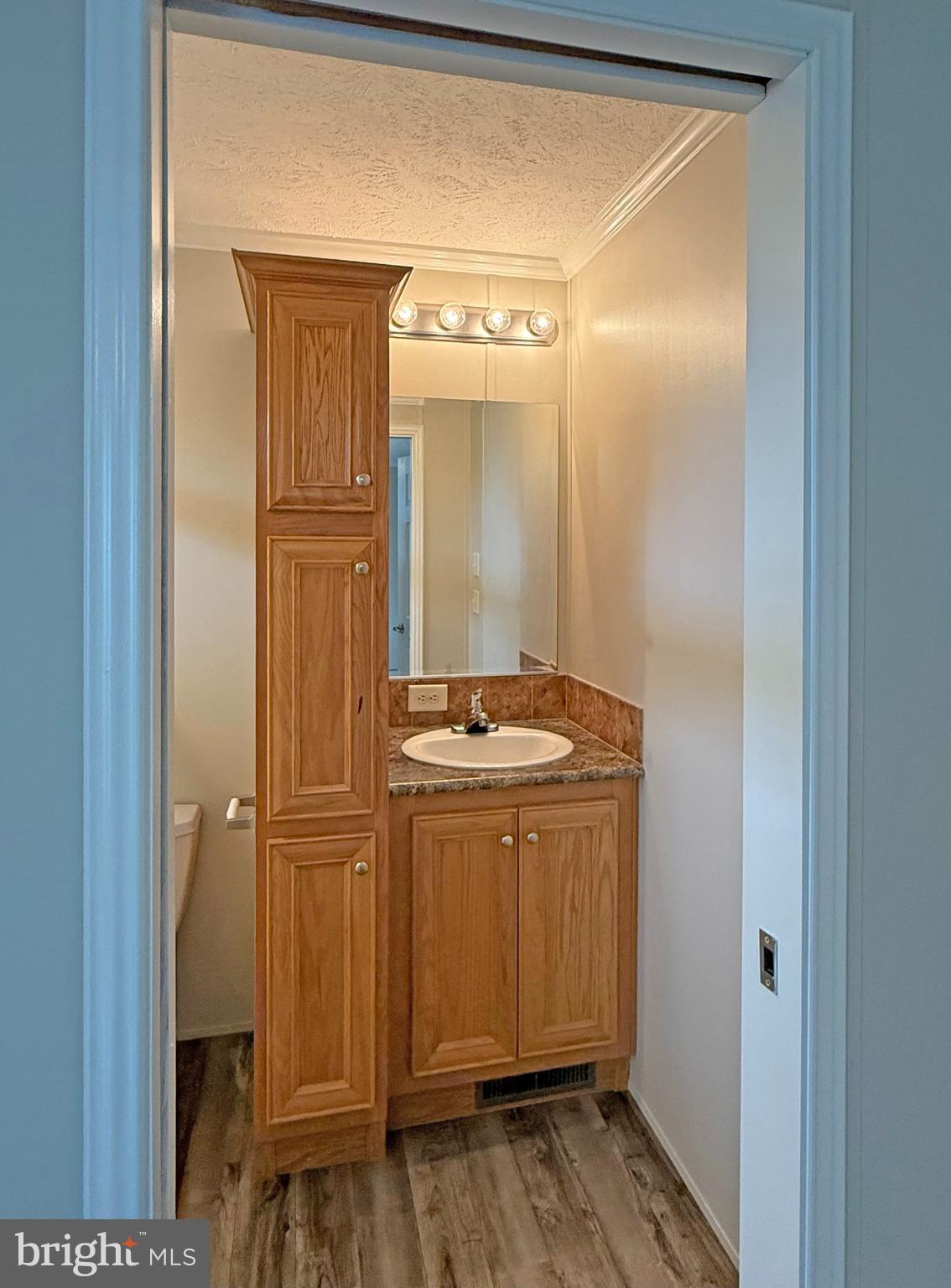 31646 Janice Road, Unit C29 Lewes, DE 19958 - Photo 15 of 34 a bathroom with a granite countertop sink and a mirror