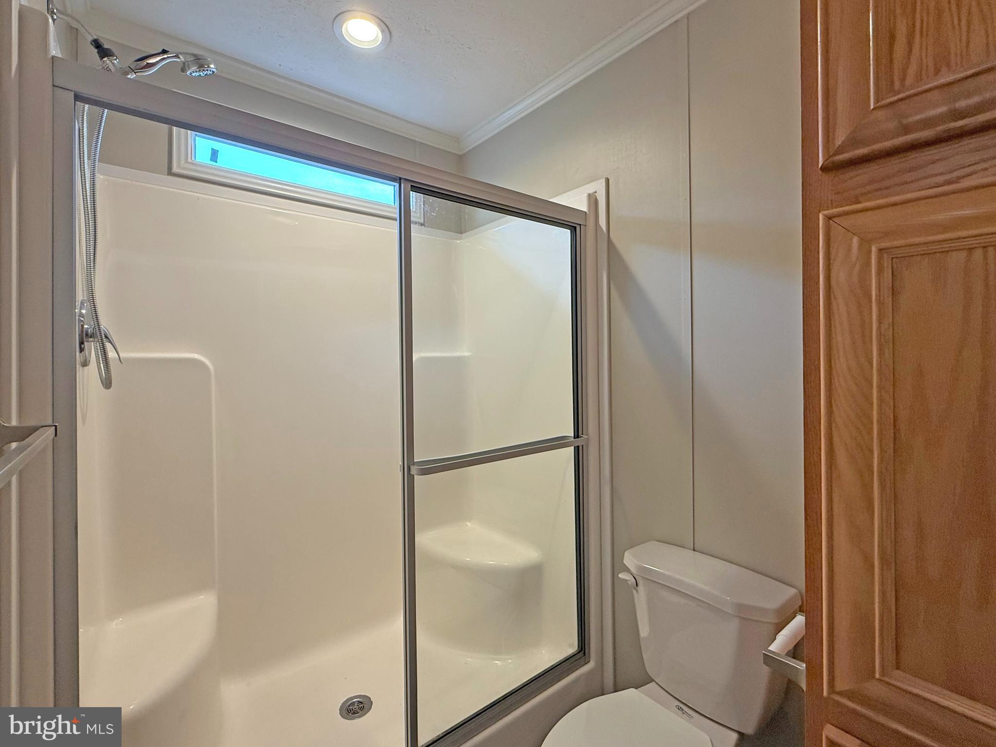 31646 Janice Road, Unit C29 Lewes, DE 19958 - Photo 16 of 34 a bathroom with a glass shower door