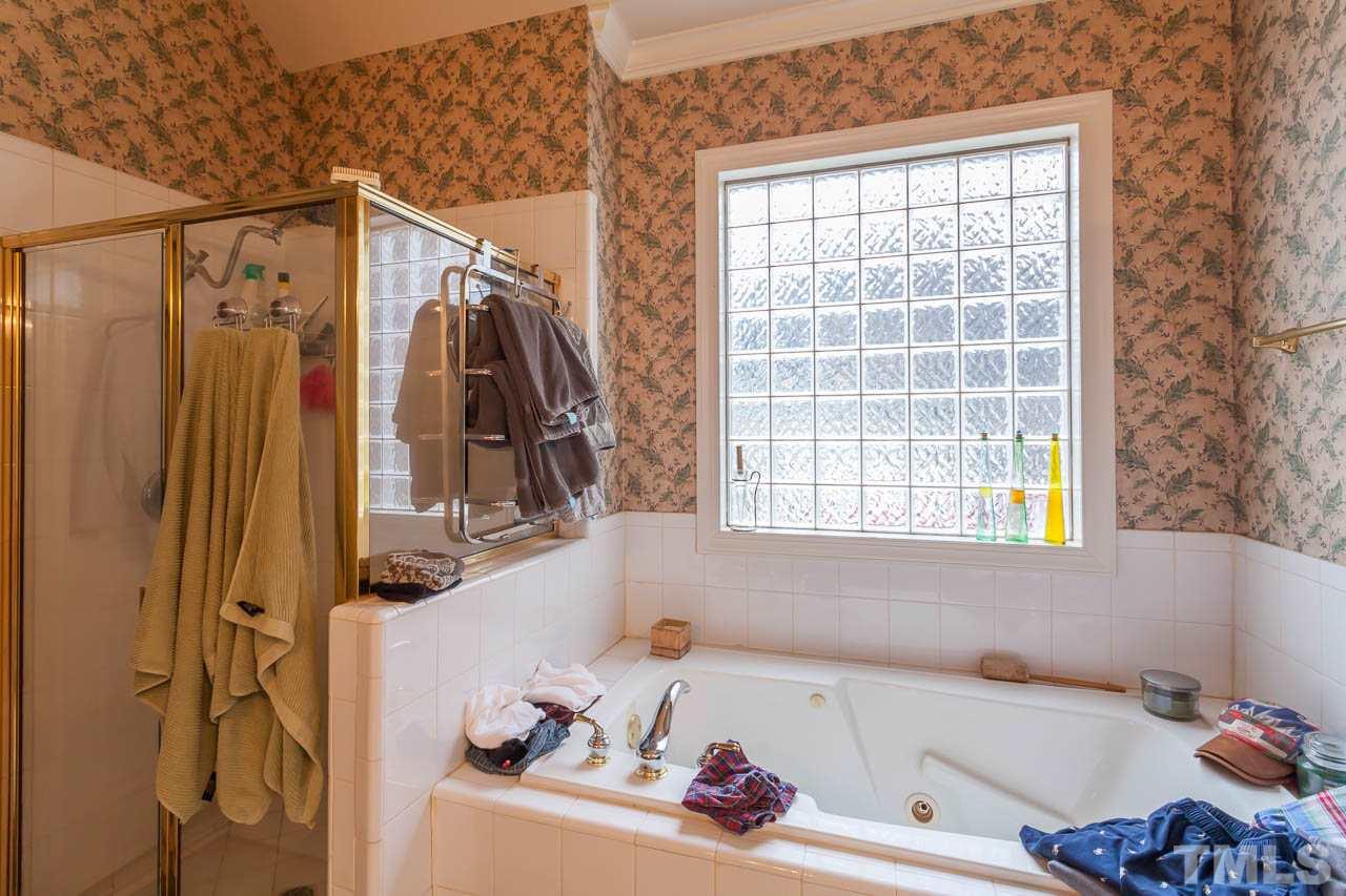 3400 Edgemont Drive Raleigh, NC 27612 - Photo 13 of 22 a bath tub sitting next to a window