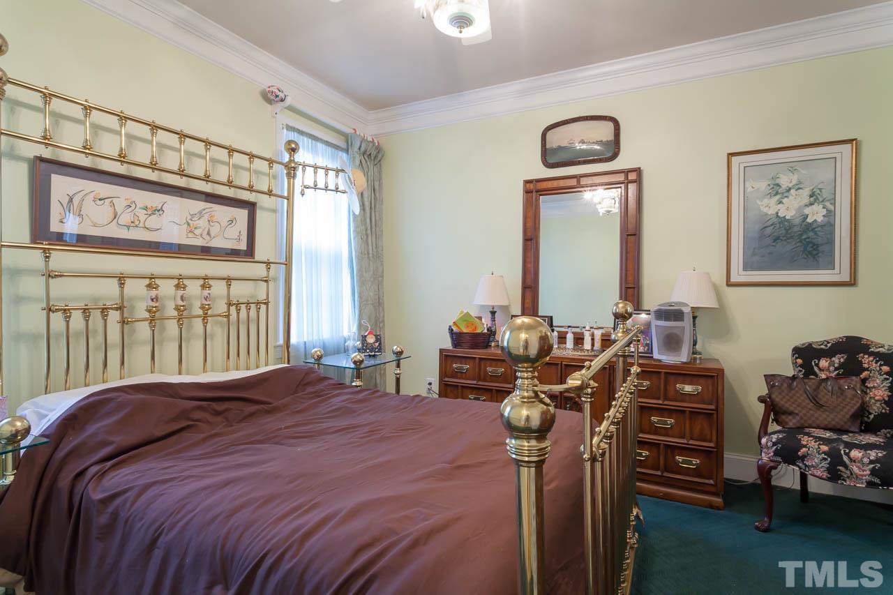 3400 Edgemont Drive Raleigh, NC 27612 - Photo 14 of 22 a bedroom with a bed and wooden floor