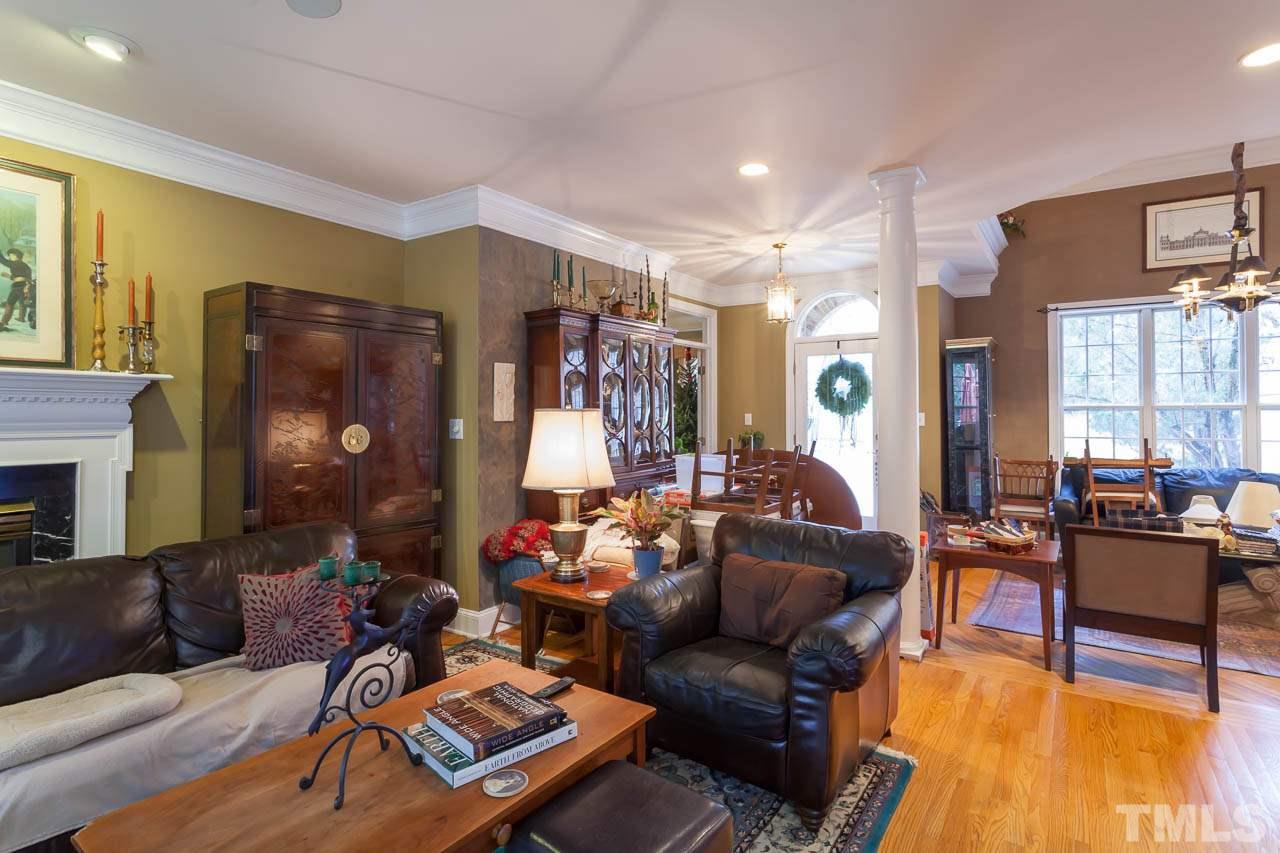 3400 Edgemont Drive Raleigh, NC 27612 - Photo 4 of 22 a living room with furniture and a chandelier