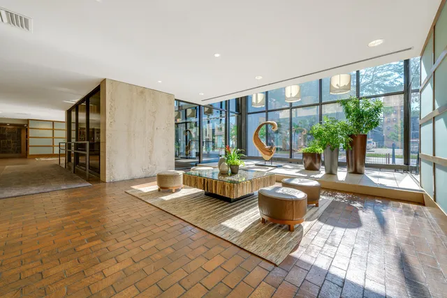 a living room with furniture and large windows