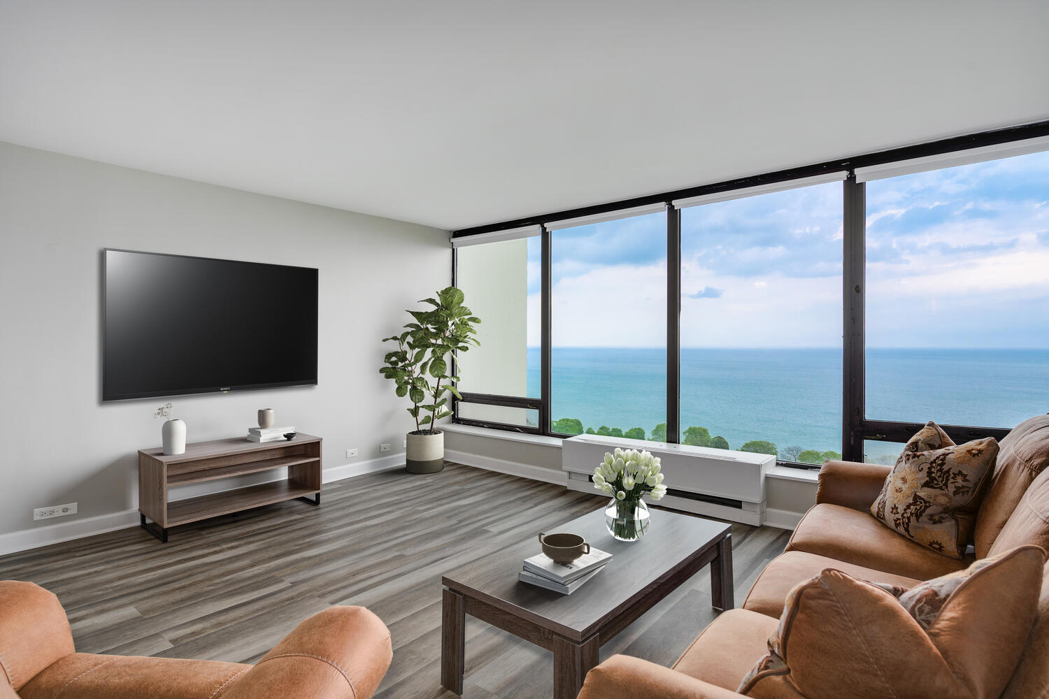 5445 North Sheridan Road, Unit 2708 Chicago, IL 60640 - Photo 8 of 16 a living room with furniture and a flat screen tv