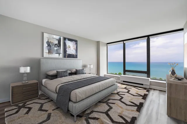 a bedroom with a bed and a large window