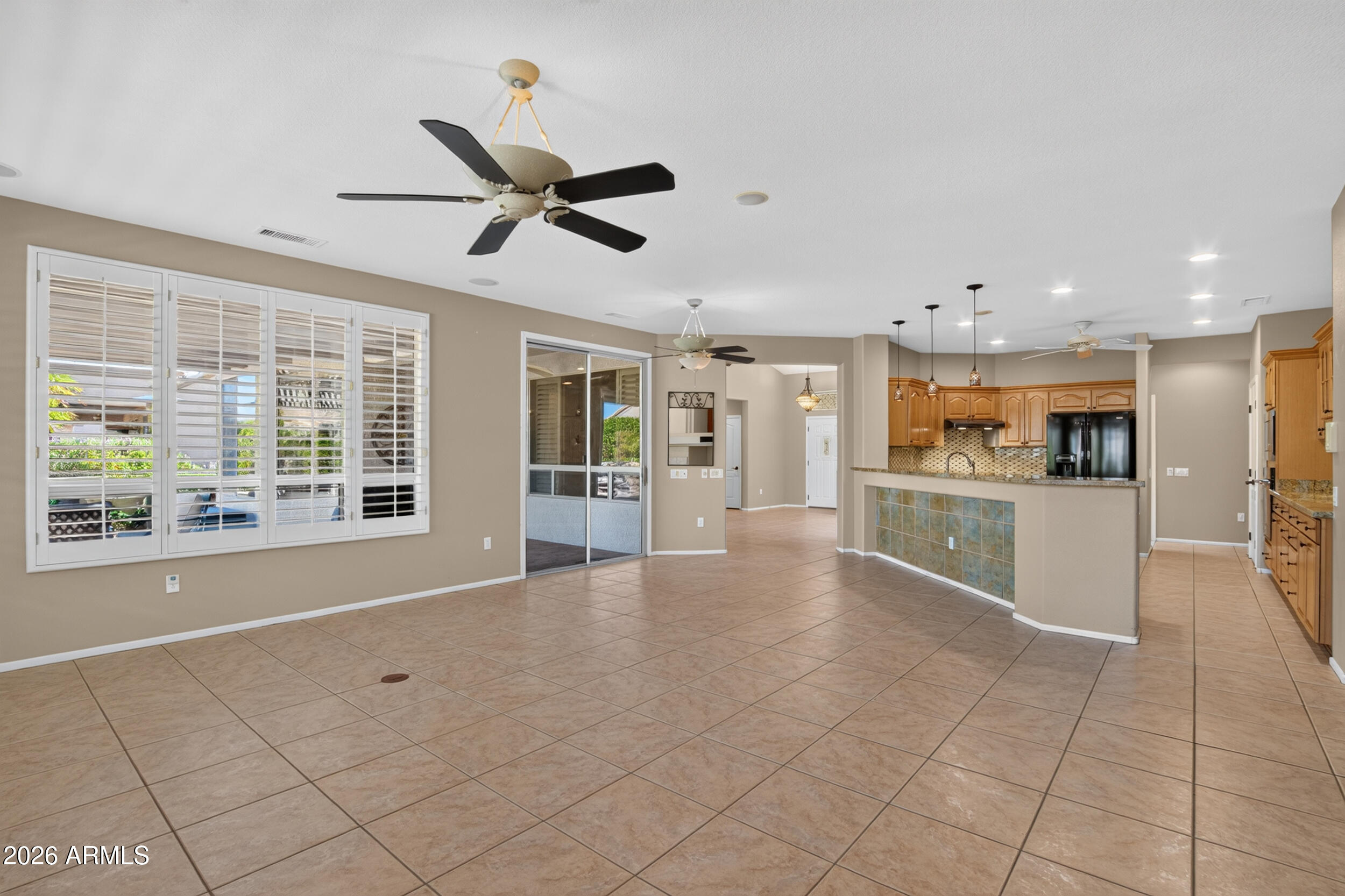 15756 West Spring Tree Way Surprise, AZ 85374 - Photo 10 of 75 Great Room Showing Kitchen & Patio