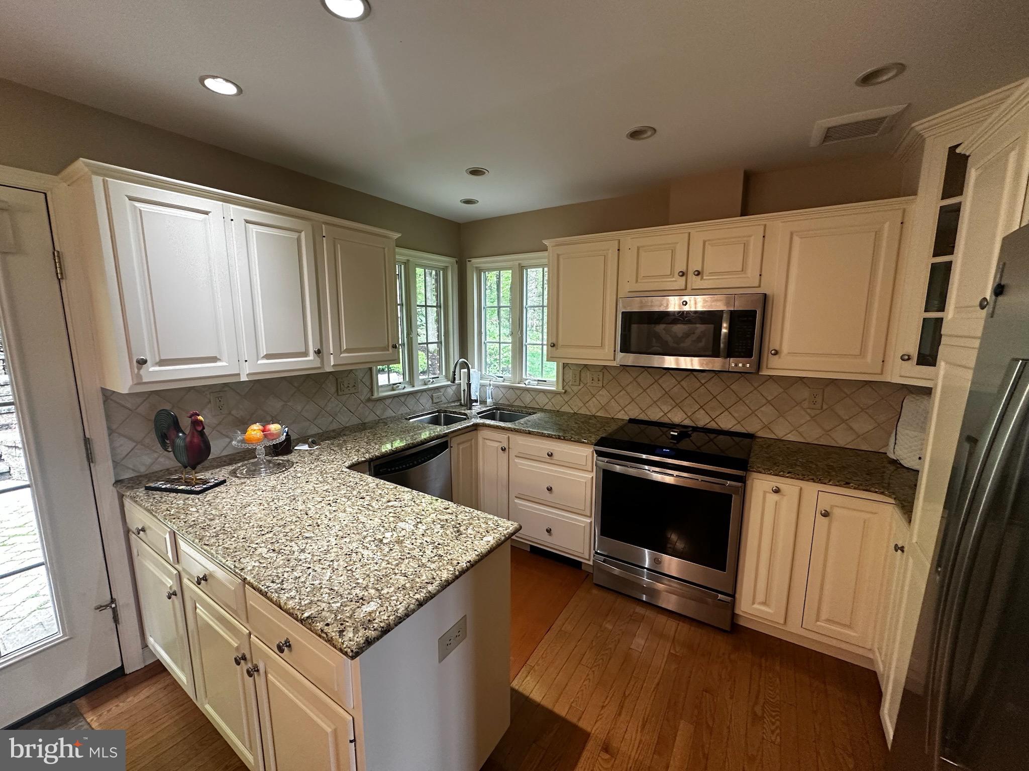 105 Northview Road Lititz, PA 17543 - Photo 25 of 38 a kitchen with stainless steel appliances granite countertop a sink stove microwave and refrigerator