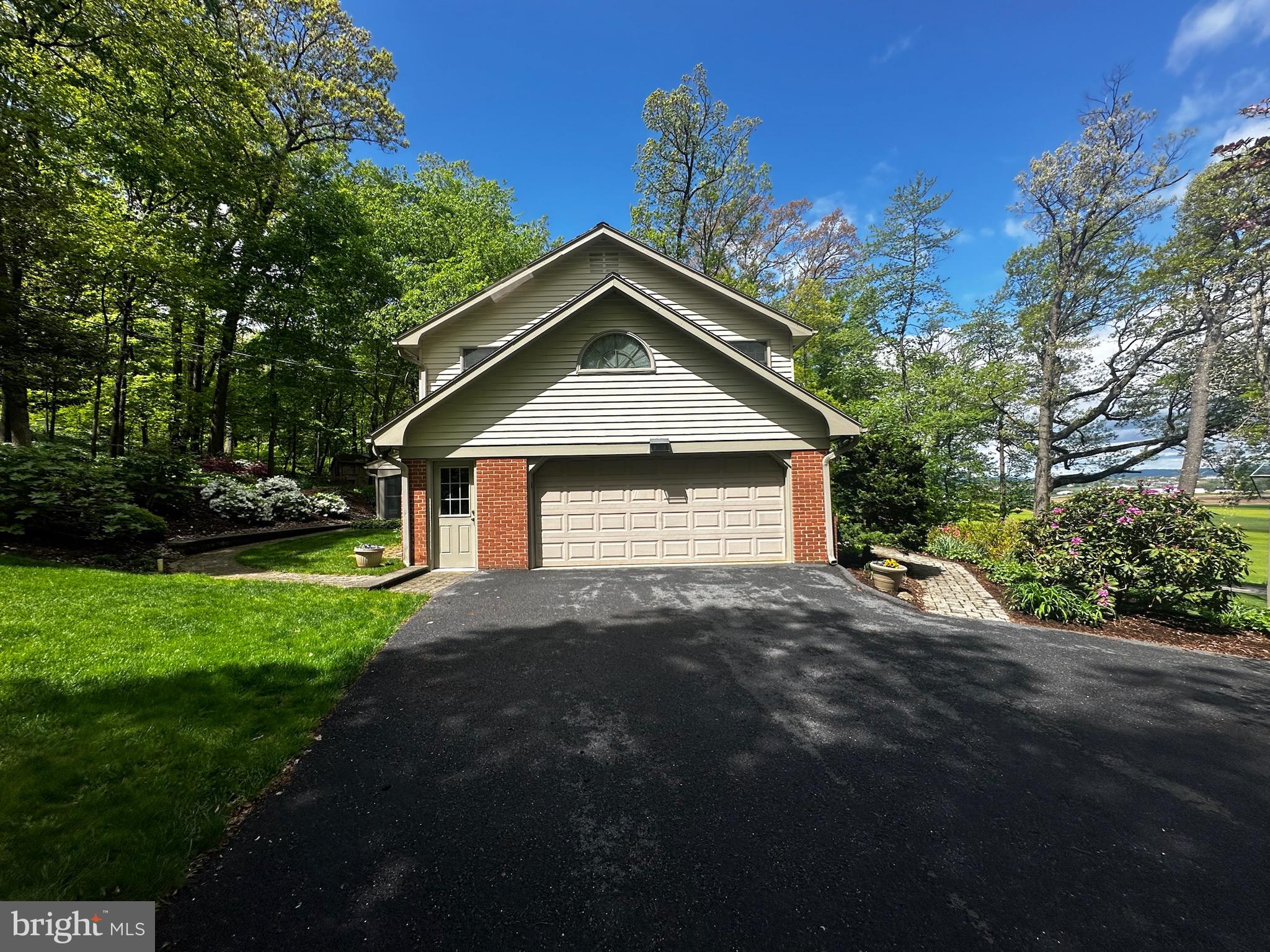 105 Northview Road Lititz, PA 17543 - Photo 5 of 38 a front view of a house with a yard and garage