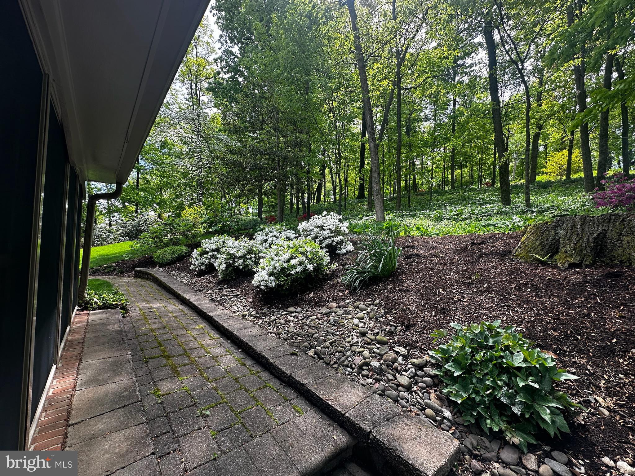 105 Northview Road Lititz, PA 17543 - Photo 8 of 38 a view of a garden with plants and a bench