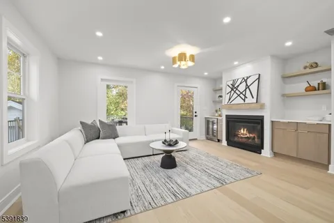 a view of a white house with a chairs in patio