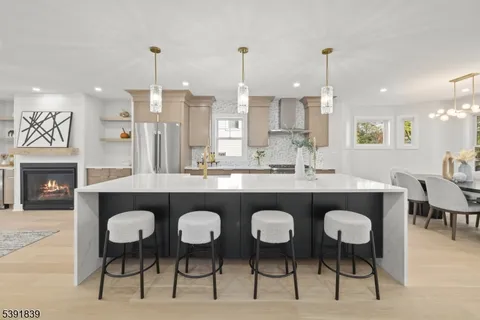 a bathroom with a toilet a sink a mirror a shower and vanity