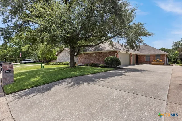 a front view of a house with a yard and a garage