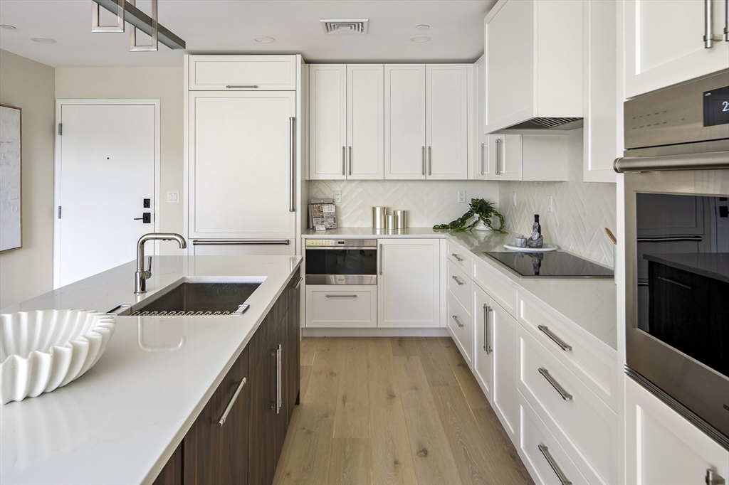 20 Kinmonth Road, Unit 4 Newton, MA 02468 - Photo 3 of 12 a kitchen with granite countertop a sink stove and cabinets