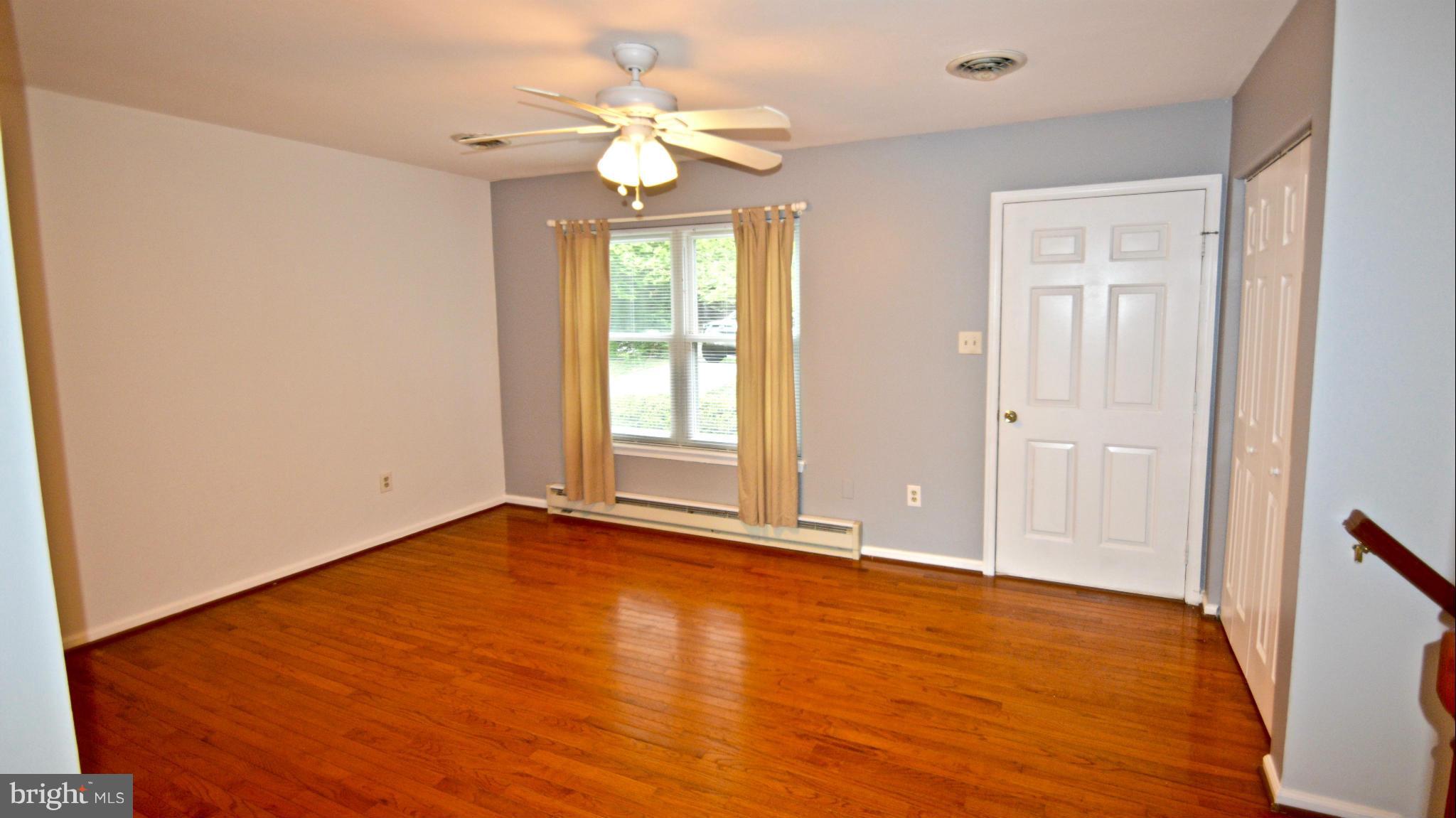 3827 Pippins Place Point of Rocks, MD 21777 - Photo 3 of 22 a view of an empty room with window and wooden floor