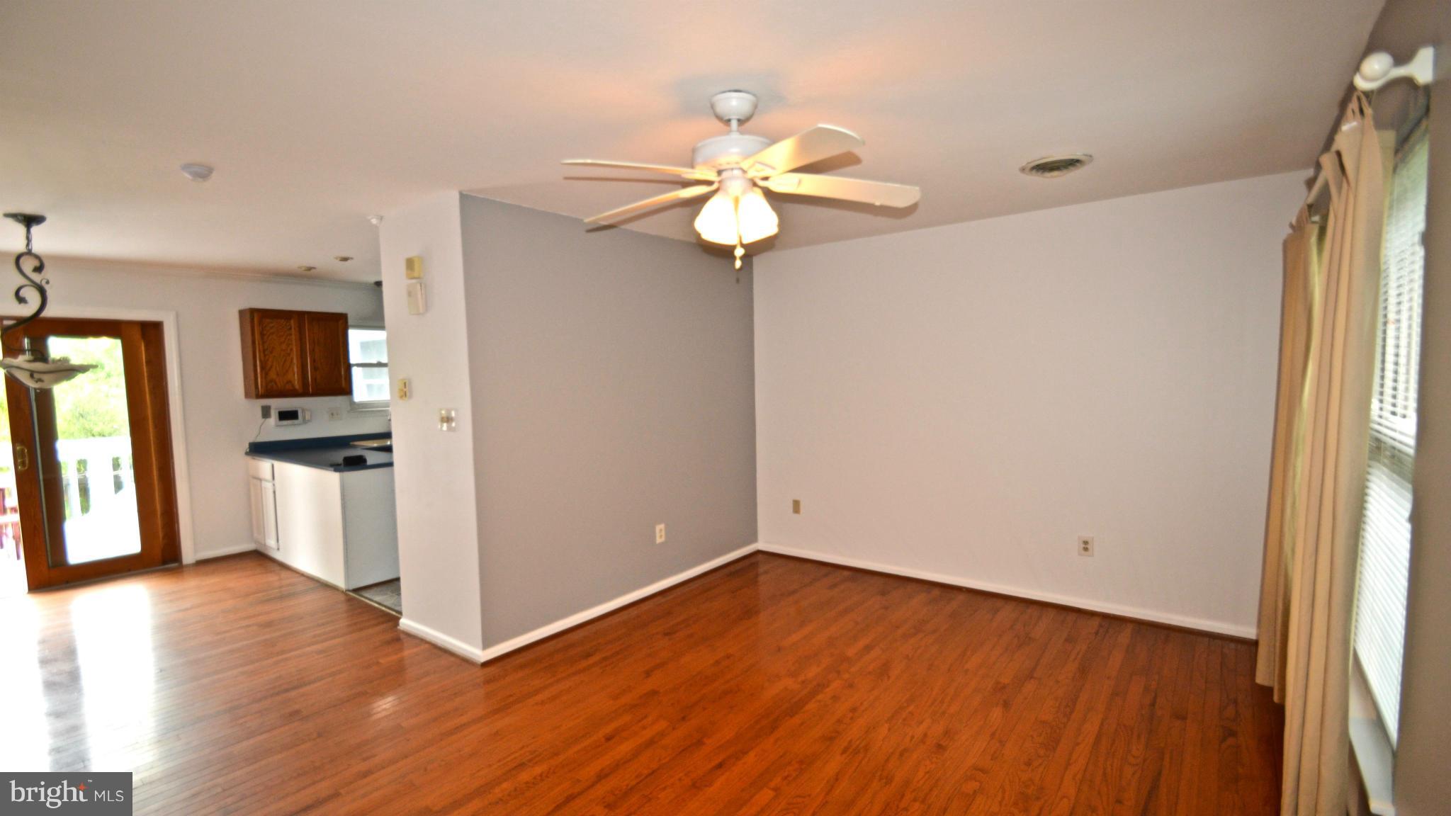 3827 Pippins Place Point of Rocks, MD 21777 - Photo 4 of 22 a view of an empty room with window and wooden floor