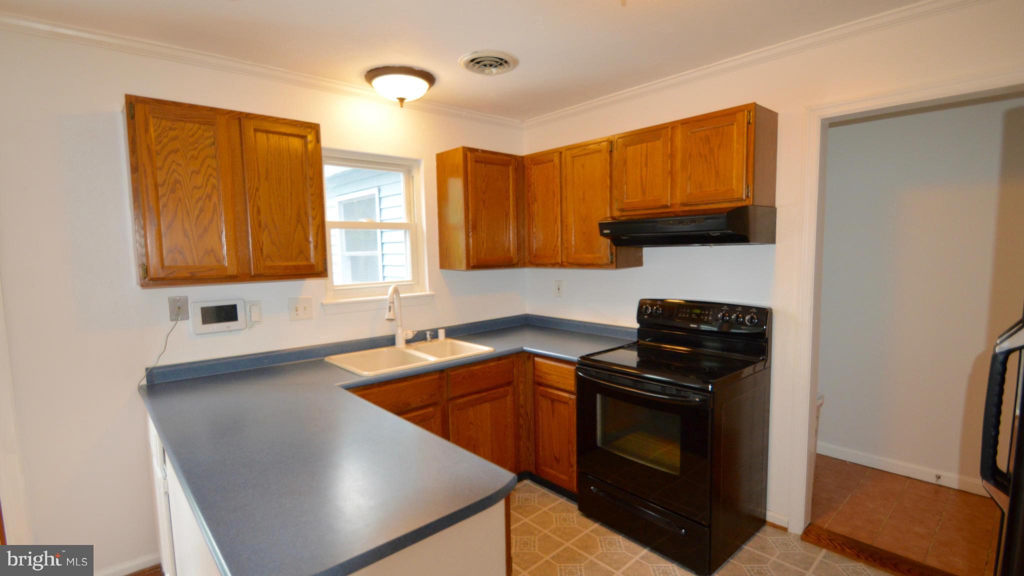 3827 Pippins Place Point of Rocks, MD 21777 - Photo 6 of 22 a kitchen with granite countertop stainless steel appliances a sink stove and refrigerator