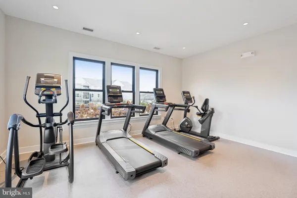 a living room with furniture a rug and kitchen view