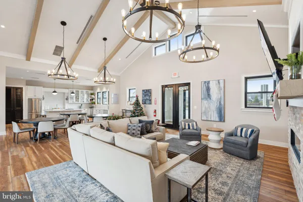 a living room with furniture a flat screen tv and a large window