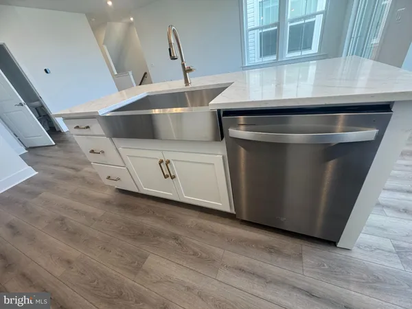 a stove top oven sitting inside of a kitchen