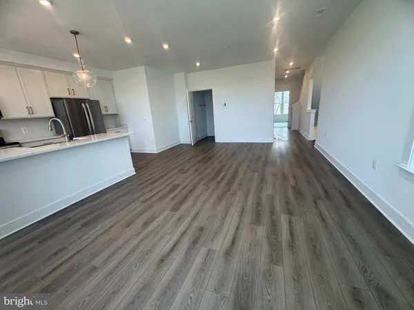a view of kitchen with wooden floor and window