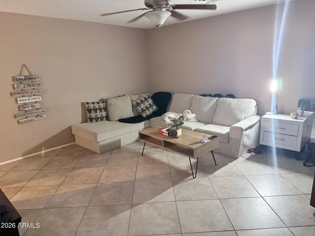 a living room with furniture and white walls