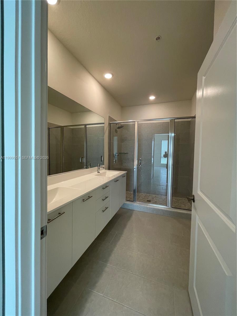 8167 Northwest 41st Street, Unit E409 Doral, FL 33166 - Photo 18 of 30 a bathroom with a sink and mirror