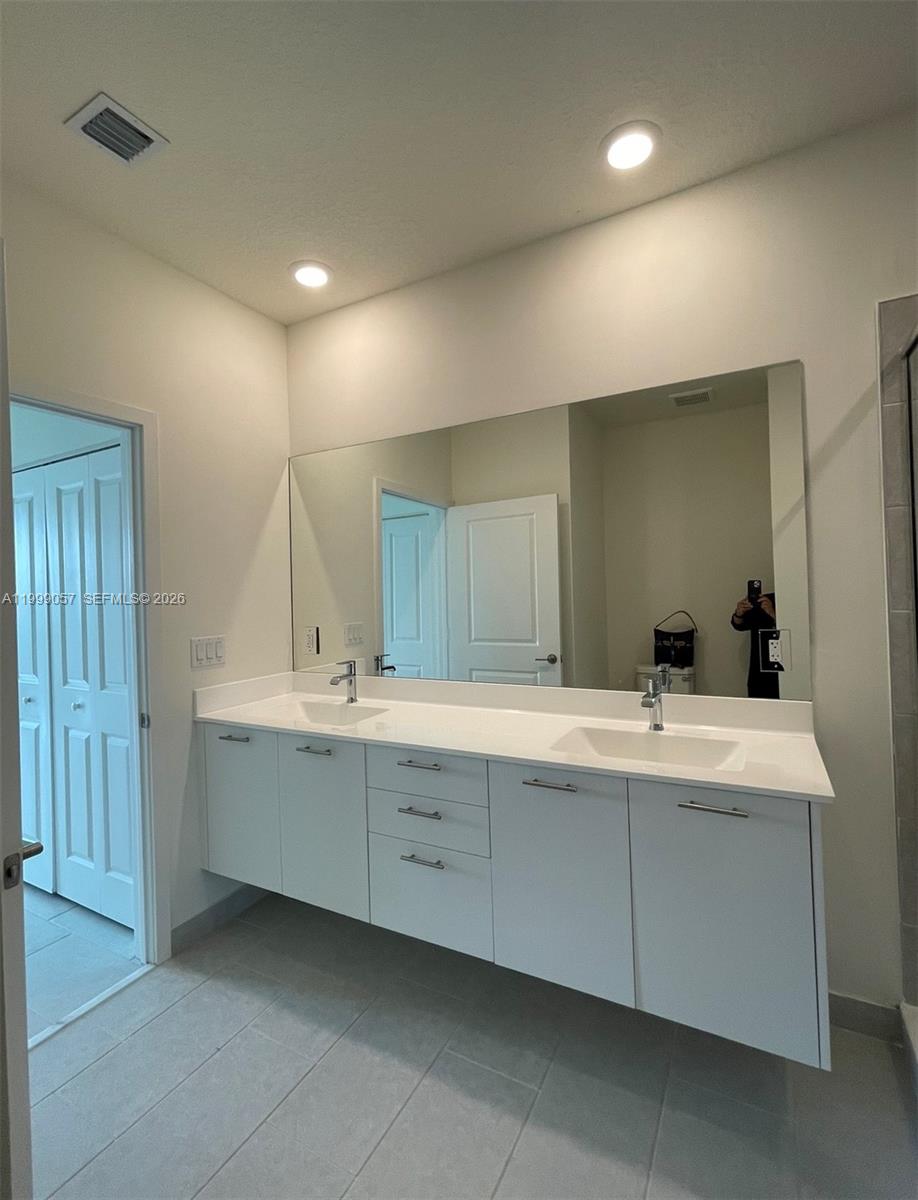 8167 Northwest 41st Street, Unit E409 Doral, FL 33166 - Photo 20 of 30 a bathroom with a sink and a mirror