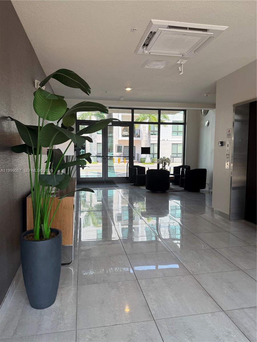 8167 Northwest 41st Street, Unit E409 Doral, FL 33166 - Photo 2 of 30 a lobby with furniture and potted plants