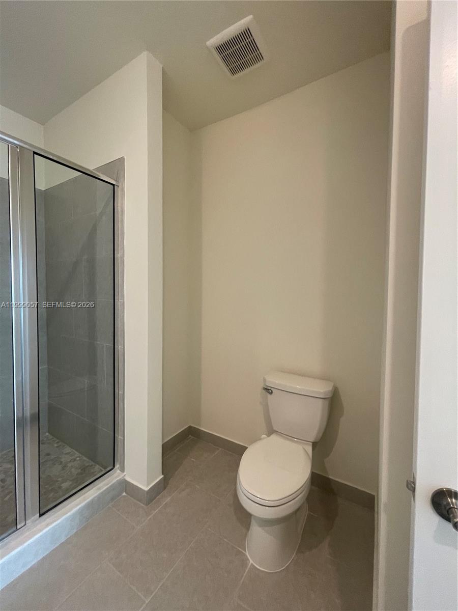 8167 Northwest 41st Street, Unit E409 Doral, FL 33166 - Photo 21 of 30 a white toilet sitting next to a bathroom sink
