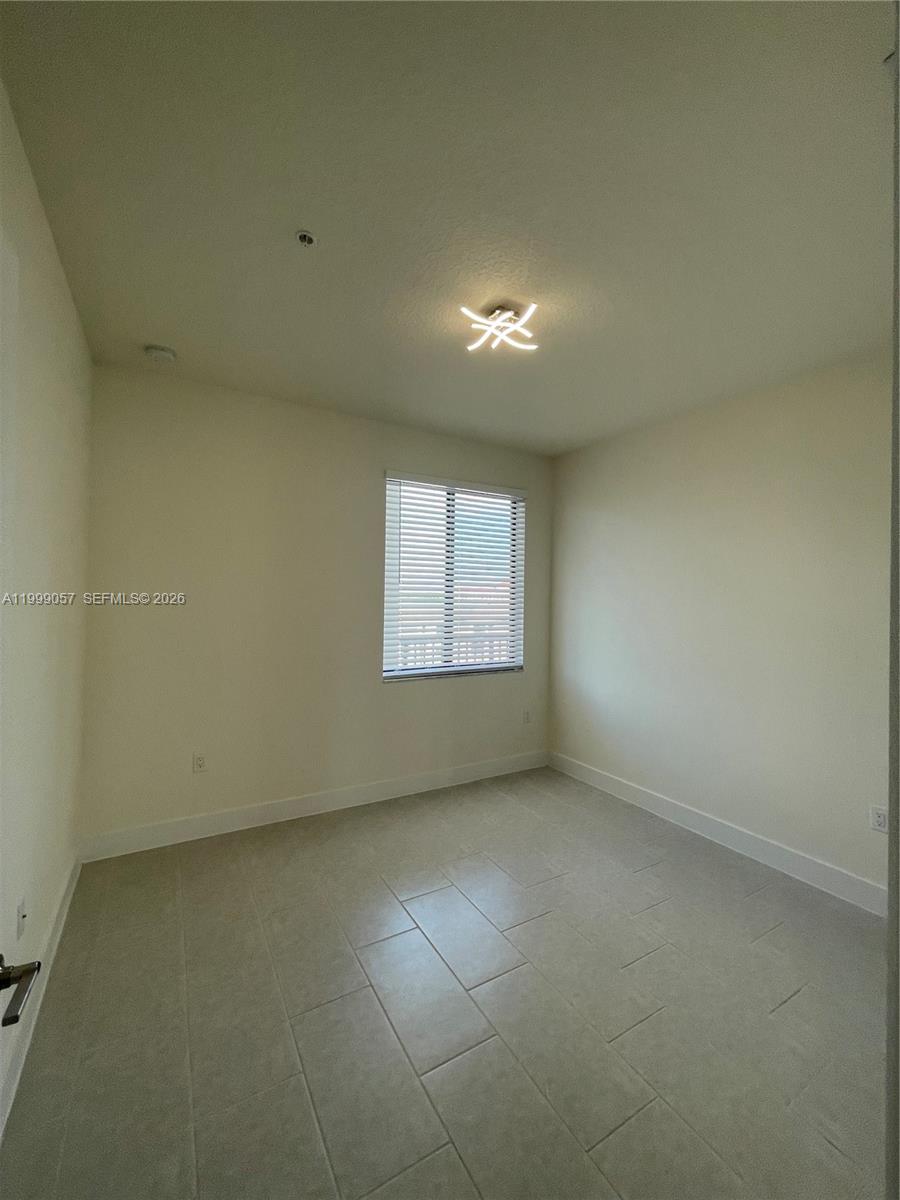 8167 Northwest 41st Street, Unit E409 Doral, FL 33166 - Photo 22 of 30 an empty room with a empty space and windows
